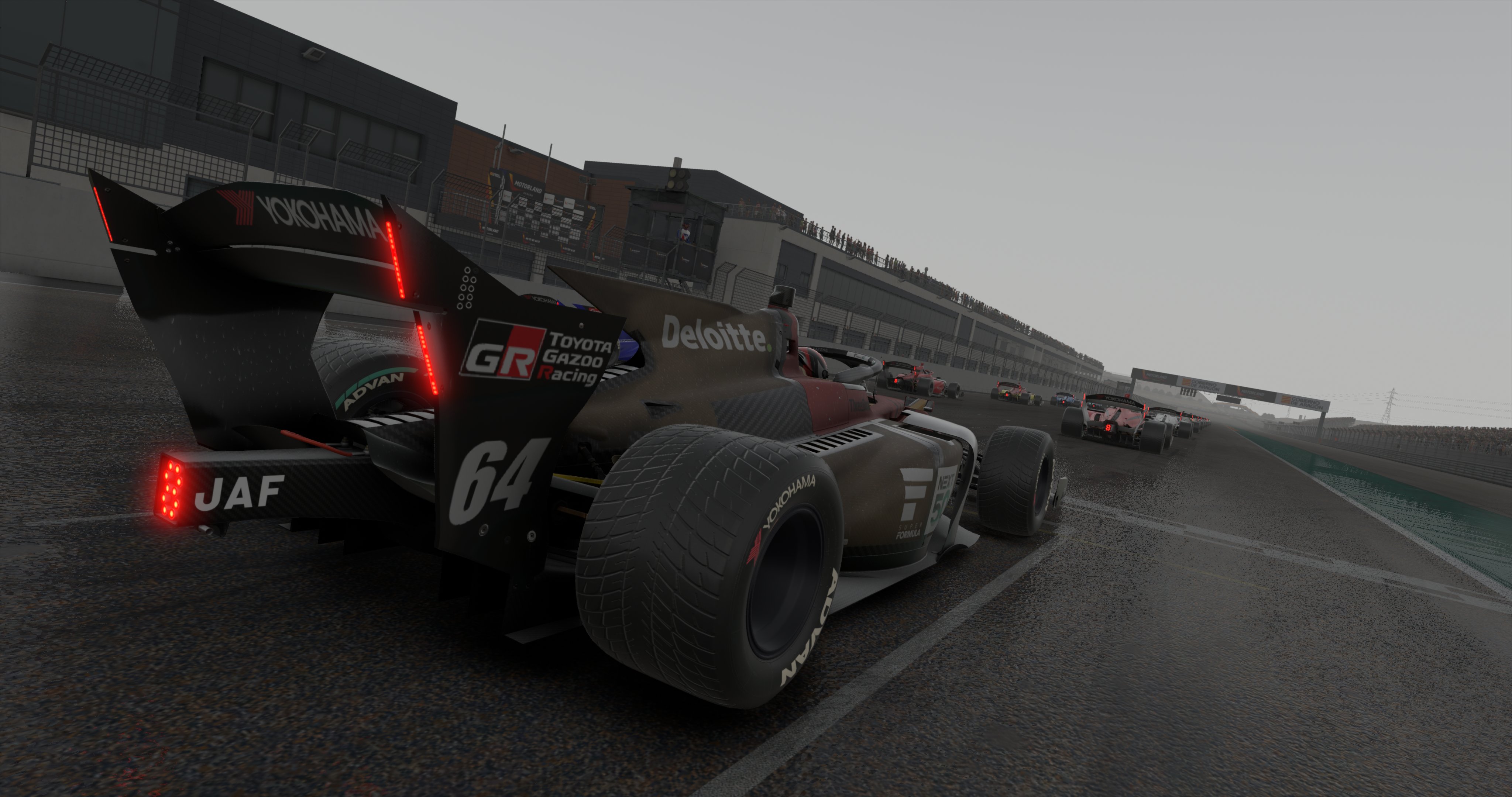 Close up of iRacing cars on start line on a grey rainy day